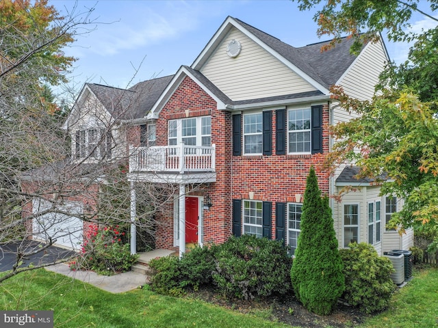 view of front of house featuring a garage, a shingled roof, aphalt driveway, cooling unit, and brick siding