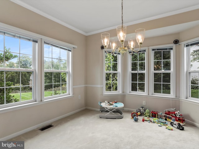 dining area featuring baseboards, crown molding, visible vents, and a healthy amount of sunlight