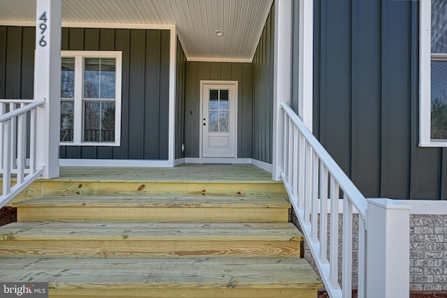 doorway to property featuring board and batten siding