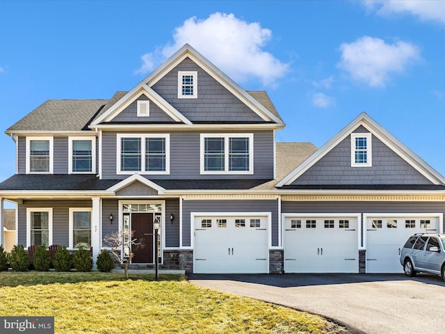 view of front of home with aphalt driveway, stone siding, a garage, and a front lawn