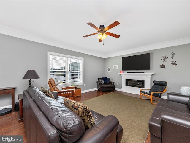 living room with a glass covered fireplace, crown molding, and wood finished floors