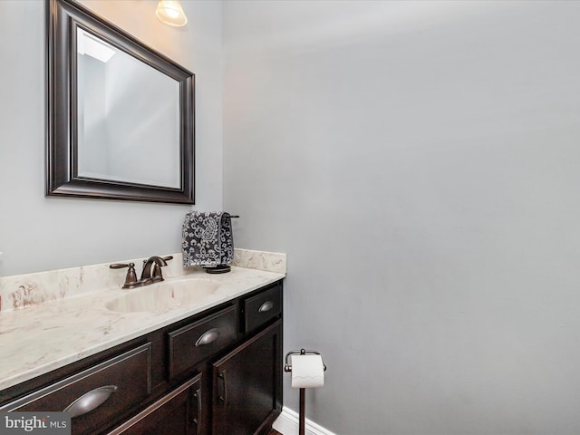 bathroom with baseboards and vanity