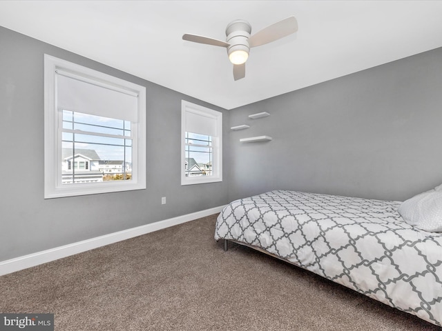 carpeted bedroom featuring ceiling fan and baseboards