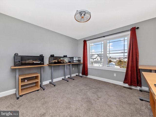 home office featuring vaulted ceiling, carpet flooring, visible vents, and baseboards