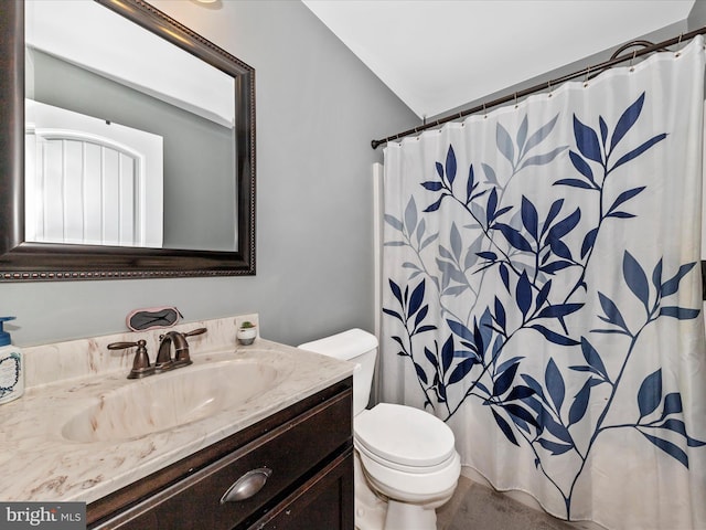 bathroom featuring curtained shower, toilet, and vanity