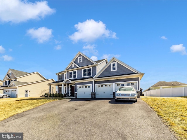 view of front of house featuring a front yard, driveway, and fence