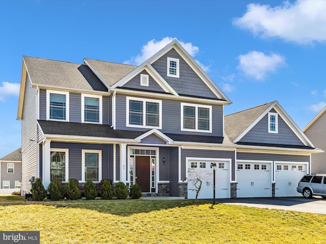 view of front facade with aphalt driveway, a shingled roof, and a front yard