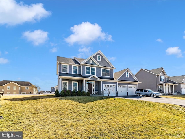 view of front of property with a garage, a residential view, a front lawn, and driveway