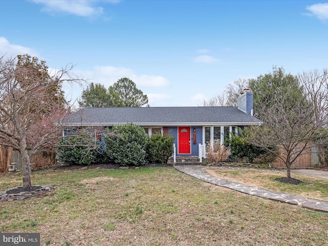 ranch-style house with a chimney, a front yard, and fence