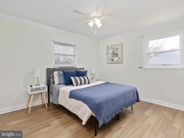 bedroom with light wood finished floors, a ceiling fan, baseboards, and crown molding