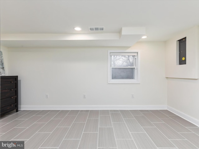 basement featuring electric panel, recessed lighting, visible vents, and baseboards