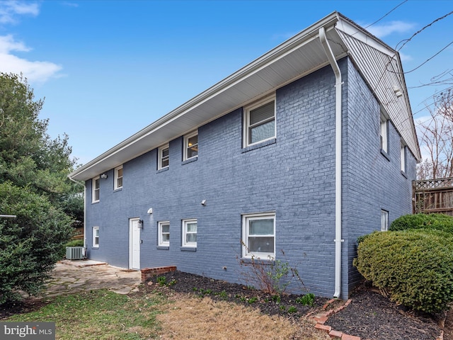 view of home's exterior featuring central air condition unit and brick siding