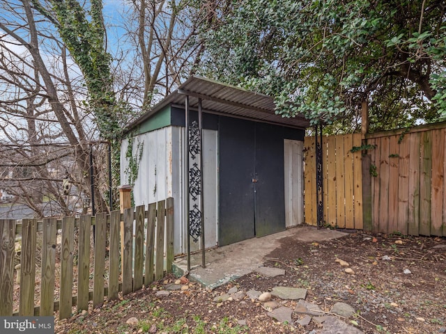 view of outbuilding featuring a fenced backyard and an outbuilding