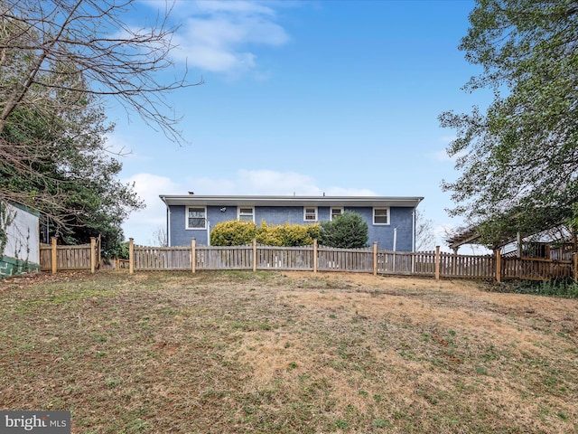 back of property featuring fence