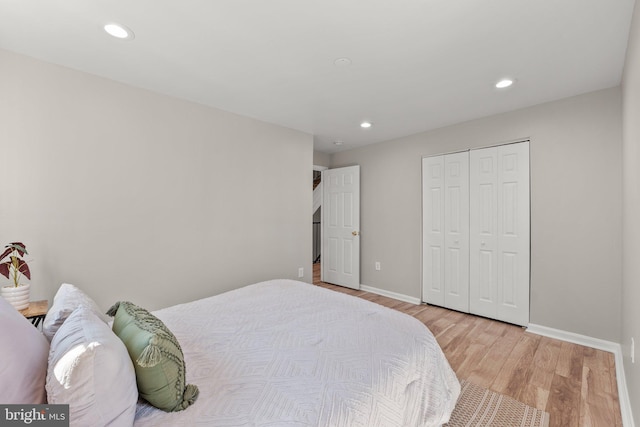 bedroom featuring recessed lighting, a closet, baseboards, and wood finished floors