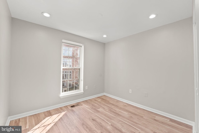 spare room featuring recessed lighting, visible vents, light wood-style flooring, and baseboards