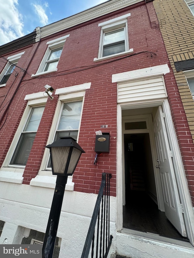 exterior space featuring brick siding