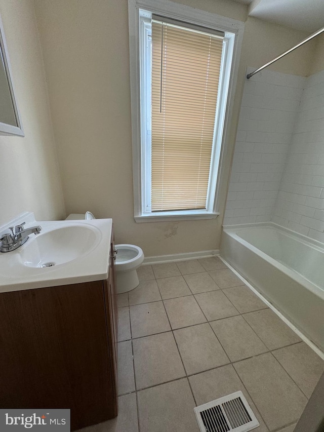 bathroom featuring visible vents, toilet, vanity, baseboards, and tile patterned floors