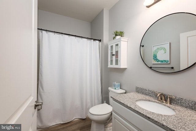 full bathroom with toilet, a shower with curtain, wood finished floors, and vanity