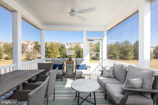 sunroom / solarium featuring a ceiling fan