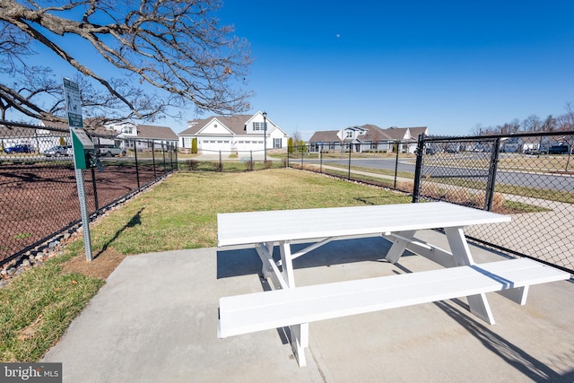 surrounding community featuring a residential view, fence, and a yard