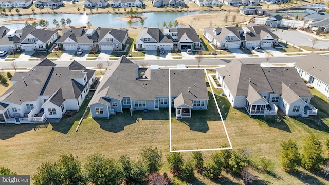 drone / aerial view featuring a water view and a residential view