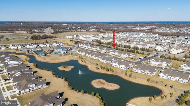 drone / aerial view featuring a water view and a residential view