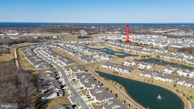 drone / aerial view with a water view and a residential view