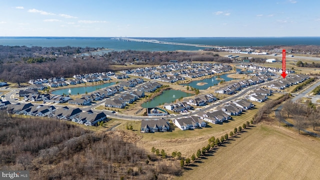 bird's eye view featuring a residential view and a water view