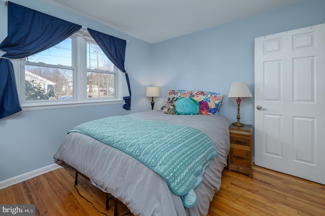 bedroom featuring wood finished floors and baseboards