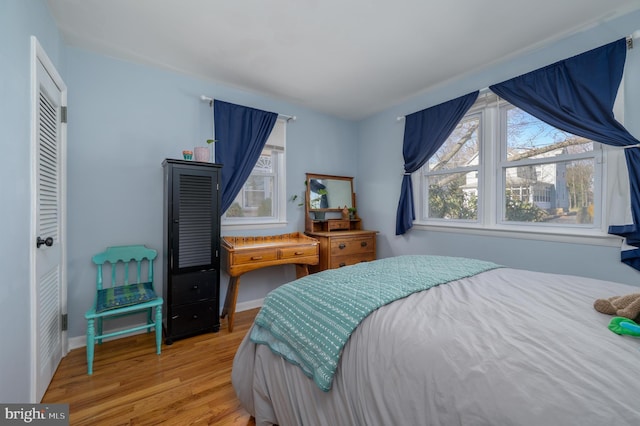 bedroom with baseboards and wood finished floors