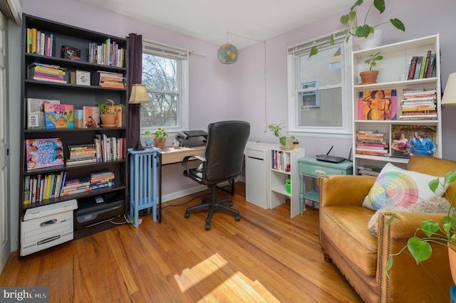 home office with wood finished floors