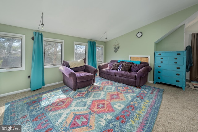 carpeted living room with baseboards and lofted ceiling