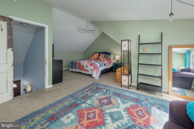 carpeted bedroom with lofted ceiling and baseboards