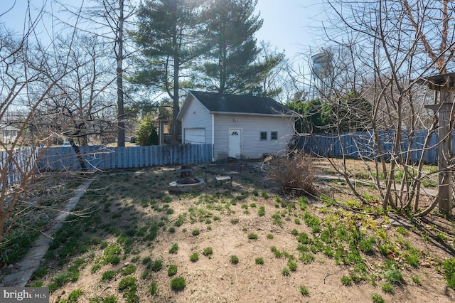 view of yard with a fire pit, an outdoor structure, and fence