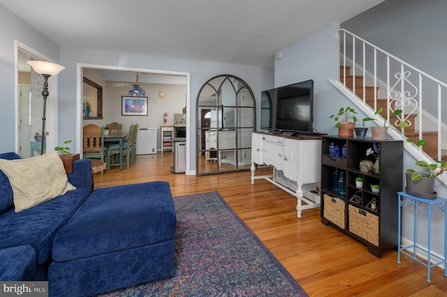 living room featuring stairs and wood finished floors