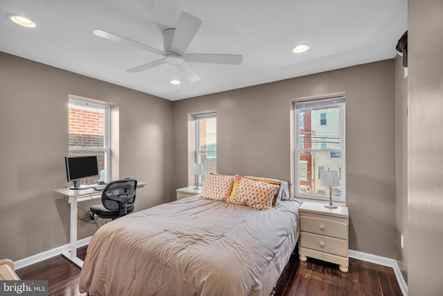 bedroom with dark wood finished floors, recessed lighting, and baseboards