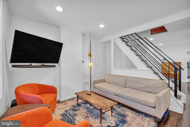 living area featuring recessed lighting, baseboards, wood finished floors, and stairs