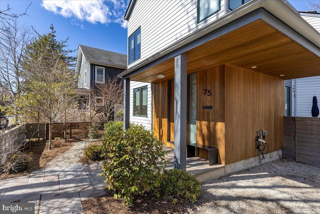 doorway to property featuring fence