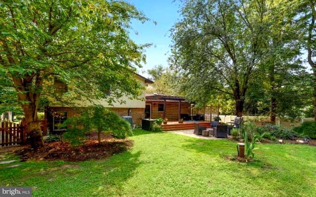 view of yard with fence and a wooden deck