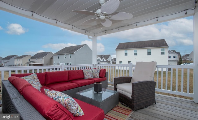 wooden deck featuring an outdoor living space, a residential view, and ceiling fan