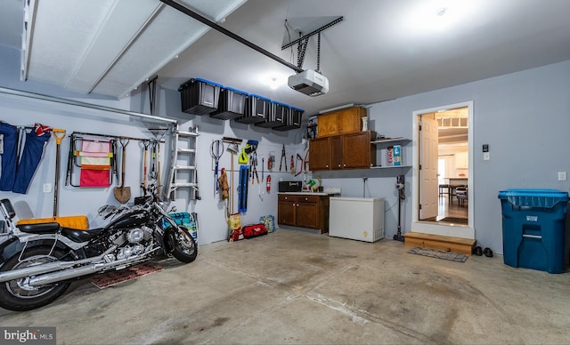 garage with fridge and a garage door opener