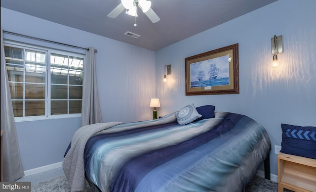 bedroom with visible vents, baseboards, and ceiling fan