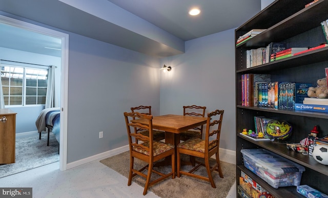 dining space with recessed lighting, baseboards, and concrete flooring