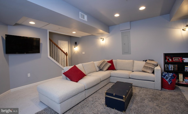 living area featuring visible vents, baseboards, stairs, electric panel, and recessed lighting