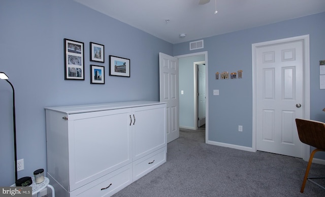 unfurnished bedroom with visible vents, baseboards, carpet, and ceiling fan