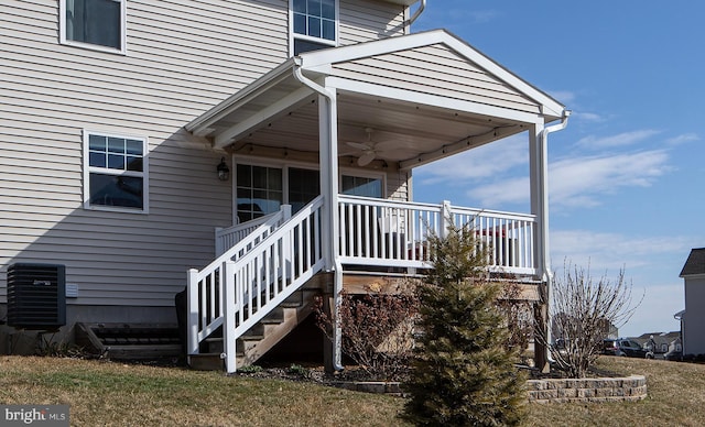 view of exterior entry with central AC and ceiling fan