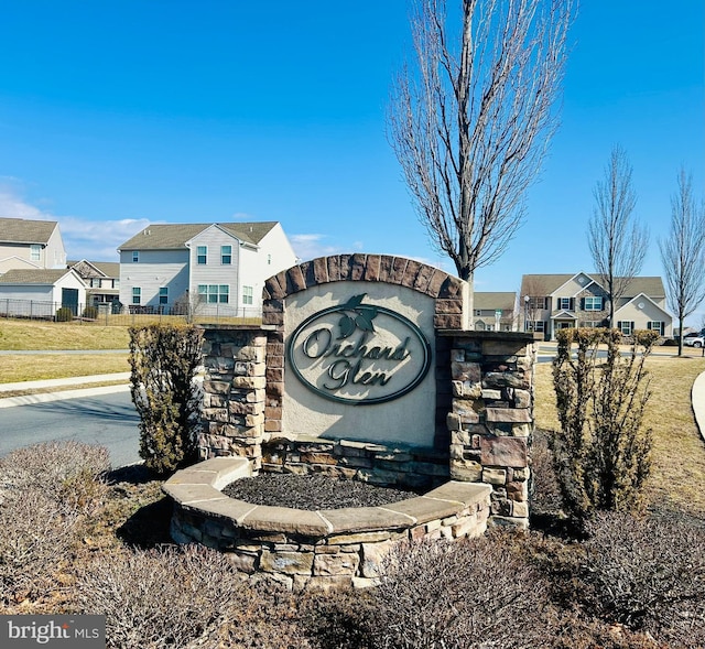 community / neighborhood sign with a residential view