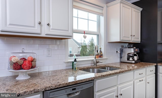 kitchen featuring a sink, dishwasher, and white cabinetry