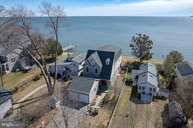 drone / aerial view with a water view and a residential view